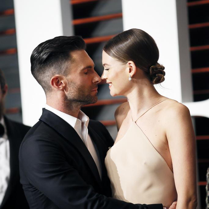 ADAM LEVINE AND WIFE, BEHATI PRINSLOO, ARRIVE AT THE 2015 VANITY FAIR OSCAR PARTY IN BEVERLY HILLS