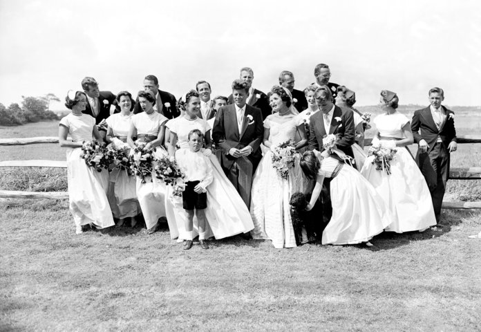 Най- couple with their twenty attendants, page boy, and flower girl on their wedding day