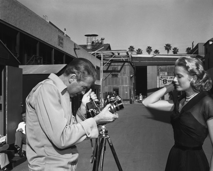 Jimmy Stewart pretends to photograph Kelly for Paramount publicity 