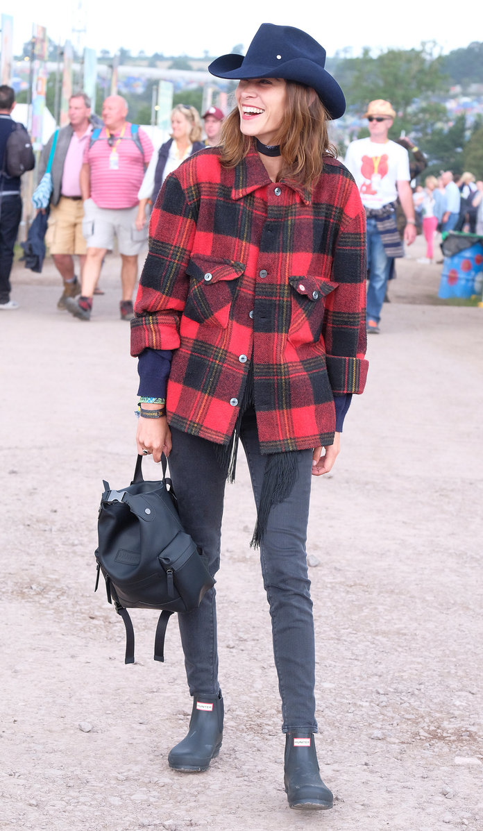 Alexa Chung lassoes a western look together for Glastonbury with Hunter Originals backpack and boots.